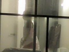 Voyeur neighbor films couple through window