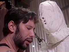 Slave in strait jacket and mask in bondage