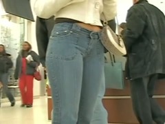 Sexy Latina girl in jeans followed by voyeur