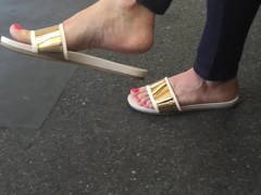 Sexy feet at London tube station, red toes dangling feet