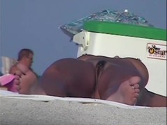 Tanned pierced marvelous babe getting recorded on the nudist beach