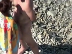 Voyeur tapes a mature couple having sex in public at the beach
