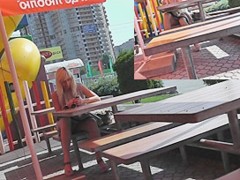 Sexy sitting upskirt in a street cafe