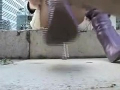 Girl in high heeled boots is exposing white thong upskirt