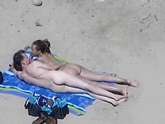 Horny couple at a nudist beach voyeur