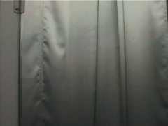 Black haired woman stripping in the store changing room