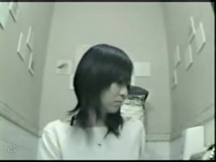 Japanese girl in jeans pissed over the toilet bowl