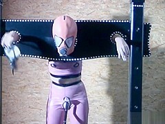 Gimp girl locked in box and pillory