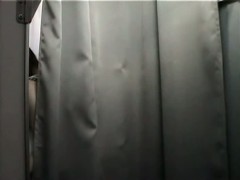 Asian trying on fake big tits on changing room hidden camera