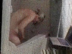 Voyeur secretly films his milf neighbor through window