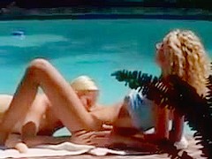 Two blondes have sex by the pool