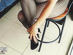 Shoe Dangling With Fishnets And Black High Heels