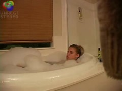 Sexy blond girl caught playing with herself in the bath