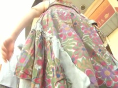 Colorful skirt is moving her ass down the street on the vid