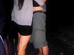 Girl in skirt sucks in a outdoor car park