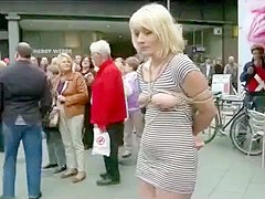 Submissive woman bound and exposed in public