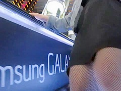 Flashing fishnet stockings tops on escalator
