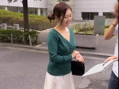 Friendly Asian gal keeps smiling while her cleavage is totally revealed