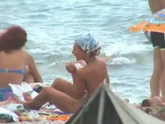 Buxom nude beach babes flaunt their jugs before a hidden camera