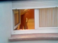 Guy made a window peep vid with a chick stripping