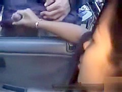Dogging girl gives handjobs out the car window