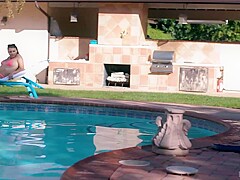 Black guy, Rob Piper is giving oral pleasure to Gia Derza, next to the swimming pool