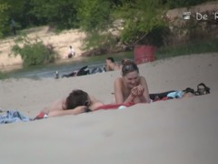 Beach voyeur video of shy topless girl sunbathing