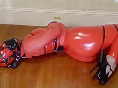 Bondage girl in latex straitjacket