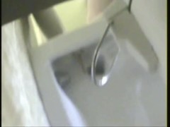 A bikini wearing girl is pissing in beach toilet