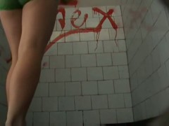 A brunette model goes to the pool bathroom to take a huge shit