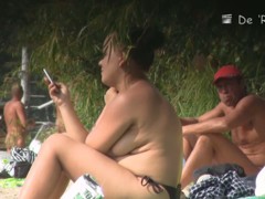 Hidden camera films beach nudist women tanning their bodies and big tits