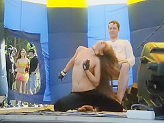 Foxy girl does a lap dance in a studio