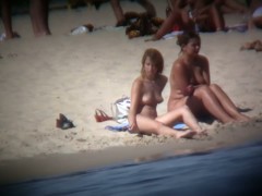 Buxom blonde filmed on a nudist beach