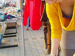 Street market seller has her big cleavage caught on the camera