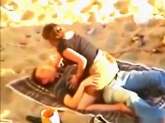 Voyeur tapes a young couple having sex at the beach