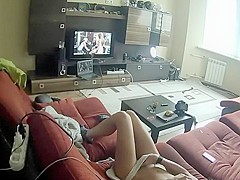 Spying a girl rubbing pussy to some porn