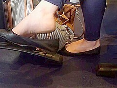 Classy Business Lady Dangling Her Black Ballerina Shoes In Public