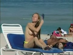 Topless beach voyeur shots of cute girls relaxing themselves