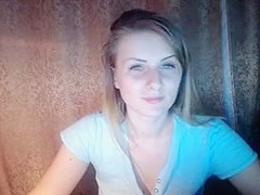 Horny blonde babe raises her blue top to show her nice tits