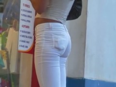 Sexy tanned babe in white captured by a hidden street cam