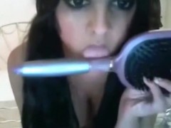 Pigtailed girl roleplays a sex fantasy online, masturbates with a hairbrush and talks dirty.